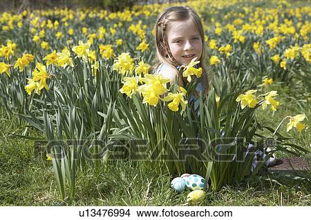 Picture - Girl On Easter Egg Hunt In Daffodil Field. Fotosearch