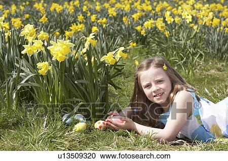 Girl On Easter Egg Hunt In Daffodil Field View Large Photo Image Stock Image - Girl On Easter Egg Hunt In Daffodil Field. Fotosearch