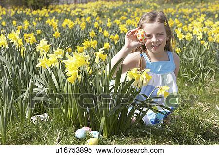 Girl On Easter Egg Hunt In Daffodil Field View Large Photo Image Stock Photography - Girl On Easter Egg Hunt In Daffodil Field. Fotosearch