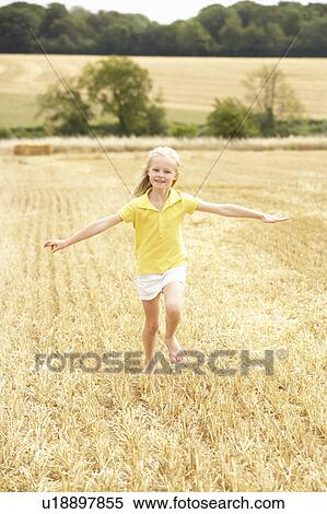Stock Photography - Girl Running Through Summer Harvested Field. Fotosearch