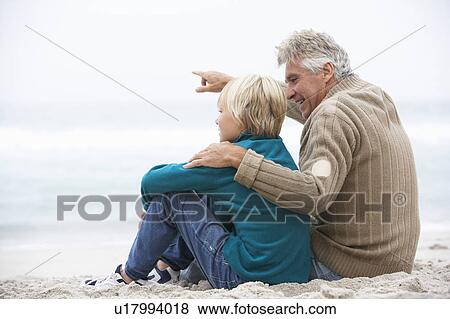 Grandfather And Son Sitting On Winter Beach Together View Large Photo Image Stock Photo - Grandfather And Son Sitting On Winter Beach Together. Fotosearch