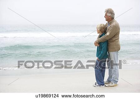 Grandfather And Son Standing On Winter Beach Together View Large Photo Image Picture - Grandfather And Son Standing On Winter Beach Together. Fotosearch