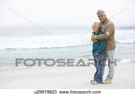 Grandfather And Son Standing On Winter Beach Together View Large Photo Image Stock Image - Grandfather And Son Standing On Winter Beach Together. Fotosearch