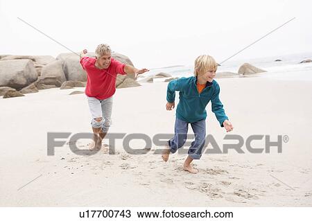 Grandfather Chasing Grandson Along Winter Beach View Large Photo Image Stock Image - Grandfather Chasing Grandson Along Winter Beach. Fotosearch