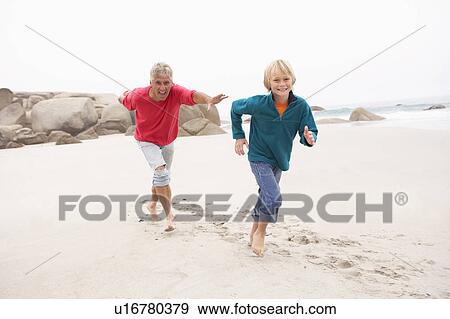Grandfather Chasing Grandson Along Winter Beach View Large Photo Image Stock Photo - Grandfather Chasing Grandson Along Winter Beach. Fotosearch