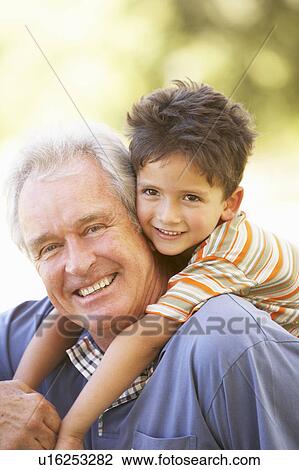 Grandfather Giving Grandson Ride On Back In Park View Large Photo Image Stock Image - Grandfather Giving Grandson Ride On Back In Park. Fotosearch