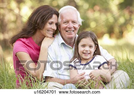Stock Image - Grandfather With Daughter And Granddaughter In Park. Fotosearch