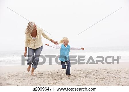 Grandmother And Granddaughter Running Along Winter Beach View Large Photo Image Stock Image - Grandmother And Granddaughter Running Along Winter Beach. Fotosearch