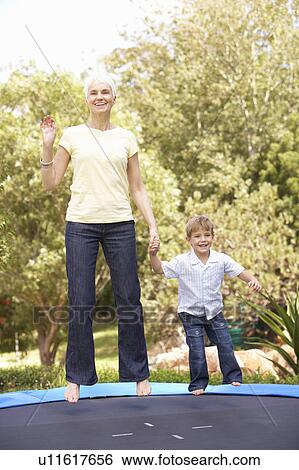 Grandmother And Grandson Jumping On Trampoline In Garden View Large Photo Image Stock Photograph - Grandmother And Grandson Jumping On Trampoline In Garden. Fotosearch
