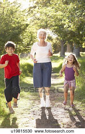 Grandmother Jogging In Park With Grandchildren View Large Photo Image Stock Image - Grandmother Jogging In Park With Grandchildren. Fotosearch