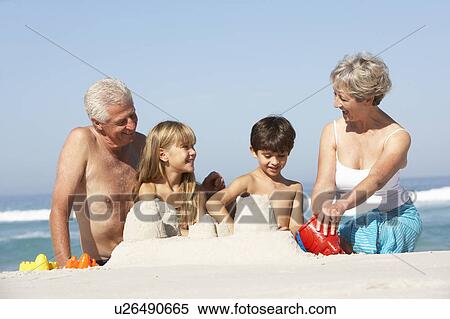 Grandparents And Grandchildren Building Sandcastles Together On Beach Holiday View Large Photo Image Stock Photography - Grandparents And Grandchildren Building Sandcastles Together On Beach Holiday. Fotosearch