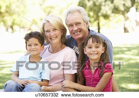 Stock Image - Grandparents And Grandchildren Enjoying Day In Park. Fotosearch