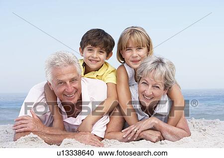 Grandparents And Grandchildren Relaxing On Beach Holiday View Large Photo Image Stock Image - Grandparents And Grandchildren Relaxing On Beach Holiday. Fotosearch