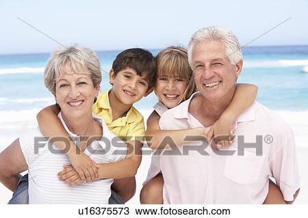 Grandparents And Grandchildren Relaxing On Beach Holiday View Large Photo Image Stock Image - Grandparents And Grandchildren Relaxing On Beach Holiday. Fotosearch