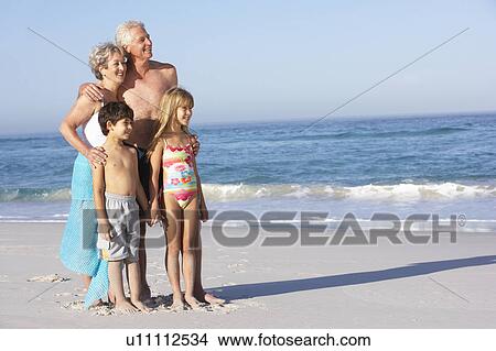 Grandparents And Grandchildren Standing On Sandy Beach View Large Photo Image Picture - Grandparents And Grandchildren Standing On Sandy Beach. Fotosearch