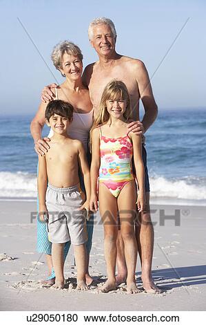 Grandparents And Grandchildren Standing On Sandy Beach View Large Photo Image Stock Image - Grandparents And Grandchildren Standing On Sandy Beach. Fotosearch