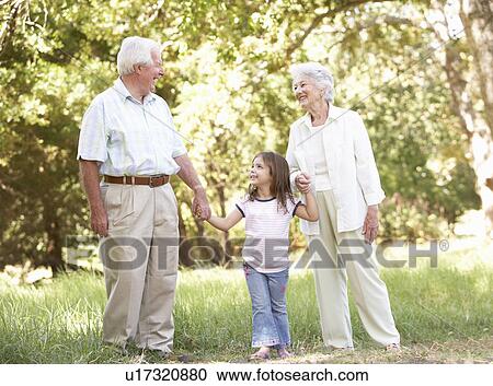 Grandparents In Park With Granddaughter View Large Photo Image Stock Image - Grandparents In Park With Granddaughter. Fotosearch
