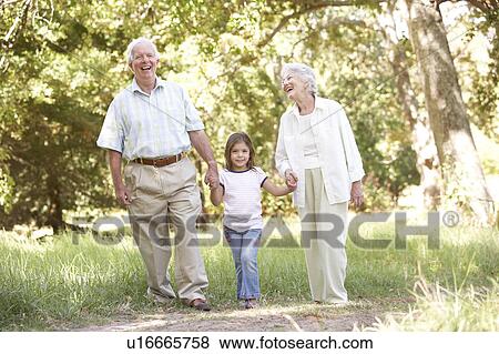 Grandparents In Park With Granddaughter View Large Photo Image Stock Photo - Grandparents In Park With Granddaughter. Fotosearch