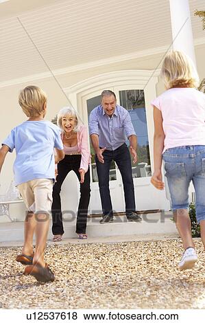 Grandparents Welcoming Grandchildren On Visit To Home View Large Photo Image Stock Photo - Grandparents Welcoming Grandchildren On Visit To Home. Fotosearch