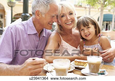 Grandparents With Granddaughter Enjoying Coffee And Cake In Café View Large Photo Image Picture - Grandparents With Granddaughter Enjoying Coffee And Cake In Café. Fotosearch