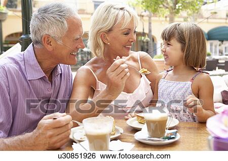 Grandparents With Granddaughter Enjoying Coffee And Cake In Café View Large Photo Image Stock Photograph - Grandparents With Granddaughter Enjoying Coffee And Cake In Café. Fotosearch