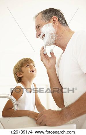 Picture - Grandson Watching Grandfather Shaving In Bathroom Mirror. Fotosearch