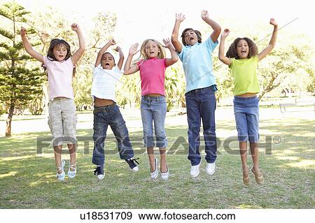 Stock Photo - Group Of Children Jumping In Air In Park. Fotosearch