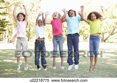 Stock Photography - Group Of Children Jumping In Air In Park. Fotosearch
