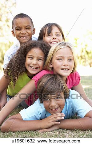 Stock Image - Group Of Children Piled Up In Park. Fotosearch