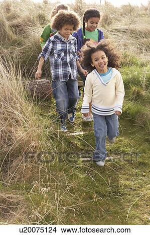 Picture - Group Of Children Playing In Field Together. Fotosearch