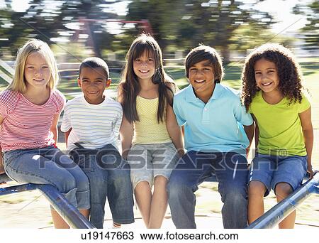 Group Of Children Riding On Roundabout In Playground View Large Photo Image Stock Image - Group Of Children Riding On Roundabout In Playground. Fotosearch