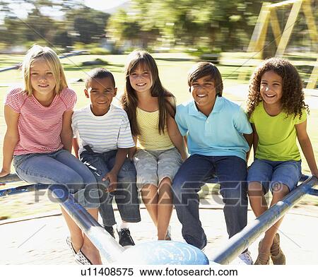 Group Of Children Riding On Roundabout In Playground View Large Photo Image Stock Photography - Group Of Children Riding On Roundabout In Playground. Fotosearch