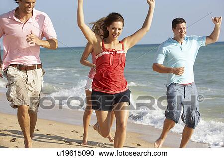 Stock Image - Group Of Friends Enjoying Beach Holiday. Fotosearch