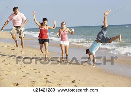 Stock Photo - Group Of Friends Enjoying Beach Holiday. Fotosearch