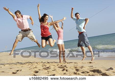 Stock Photography - Group Of Friends Enjoying Beach Holiday. Fotosearch