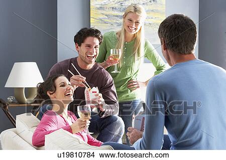 Picture - Group Of Friends Enjoying Chinese Takeaway Meal At Home. Fotosearch