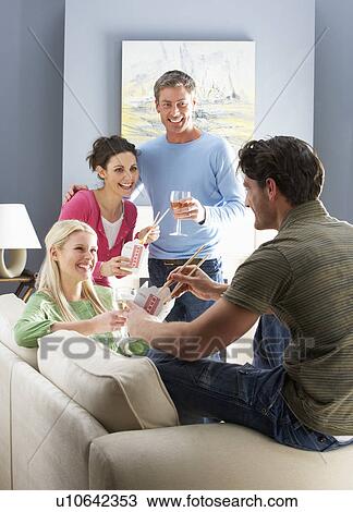 Group Of Friends Enjoying Chinese Takeaway Meal At Home View Large Photo Image Stock Image - Group Of Friends Enjoying Chinese Takeaway Meal At Home. Fotosearch