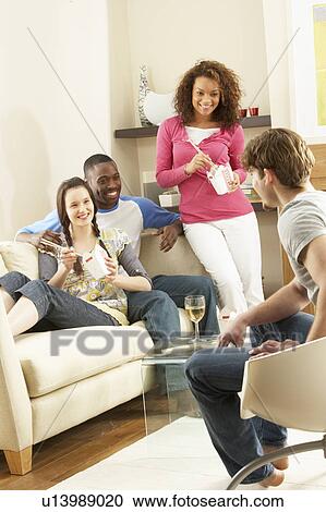 Group Of Friends Enjoying Chinese Takeaway Meal At Home View Large Photo Image Stock Image - Group Of Friends Enjoying Chinese Takeaway Meal At Home. Fotosearch