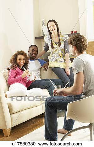 Group Of Friends Enjoying Chinese Takeaway Meal At Home View Large Photo Image Stock Image - Group Of Friends Enjoying Chinese Takeaway Meal At Home. Fotosearch