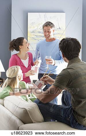 Group Of Friends Enjoying Chinese Takeaway Meal At Home View Large Photo Image Stock Image - Group Of Friends Enjoying Chinese Takeaway Meal At Home. Fotosearch