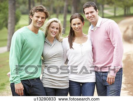 Group of friends enjoying walk in park View Large Photo Image Stock Image - Group of friends enjoying walk in park. Fotosearch