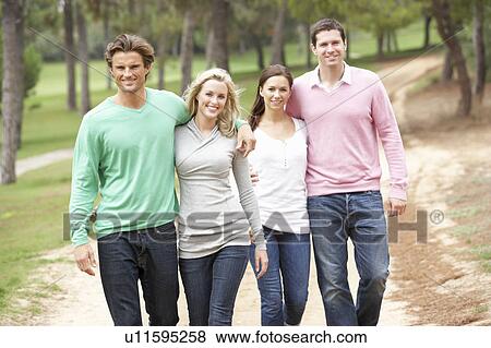 Stock Photo - Group of friends enjoying walk in park. Fotosearch