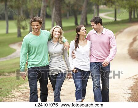 Stock Photograph - Group of friends enjoying walk in park. Fotosearch