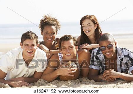 Group Of Friends Relaxing On Beach With Football Together View Large Photo Image Stock Image - Group Of Friends Relaxing On Beach With Football Together. Fotosearch