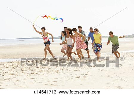 Group Of Friends Running Along Beach Together View Large Photo Image Stock Image - Group Of Friends Running Along Beach Together. Fotosearch