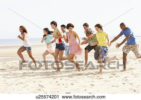 Group Of Friends Running Along Beach Together View Large Photo Image Stock Image - Group Of Friends Running Along Beach Together. Fotosearch