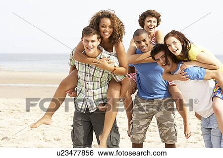 Group Of Friends Running Along Beach Together View Large Photo Image Stock Photograph - Group Of Friends Running Along Beach Together. Fotosearch