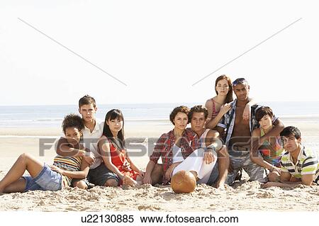 Group Of Friends Sitting On Beach Together View Large Photo Image Stock Photography - Group Of Friends Sitting On Beach Together. Fotosearch