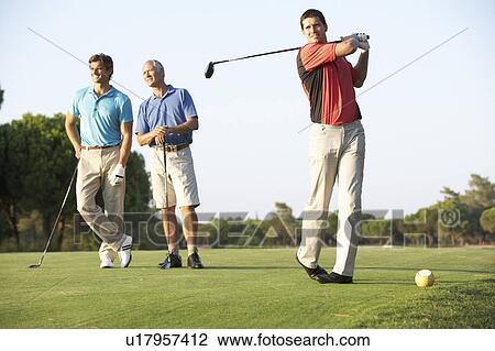 Group Of Male Golfers Teeing Off On Golf Course View Large Photo Image Stock Image - Group Of Male Golfers Teeing Off On Golf Course. Fotosearch