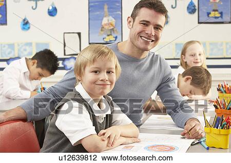Group Of Primary Schoolchildren And Teacher Having lesson In Classroom View Large Photo Image Stock Image - Group Of Primary Schoolchildren And Teacher Having lesson In Classroom. Fotosearch